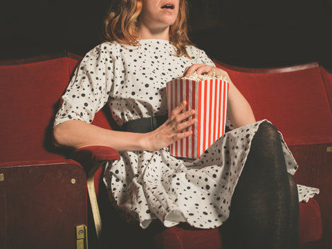 Young woman on front row of movie theater