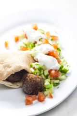 meatball in pan pita with tomato and cucumber salad