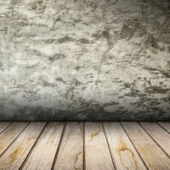 Old interior with concrete wall and wooden floor.