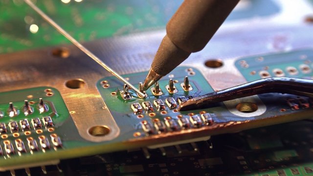 Soldering on a PCB (4K UHD detailed macro footage)