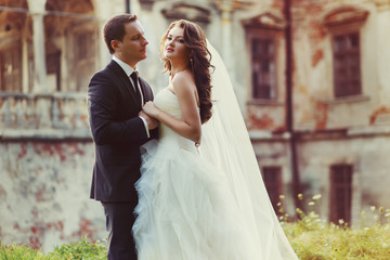 Naklejka premium two couple after wedding in tne park near the castle