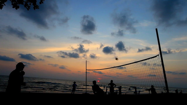 people enjoy play volleyball on twilight beach