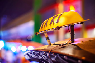 Thai Taxi (Tuk Tuk) sign with defocused lights blur , Chiang Mai