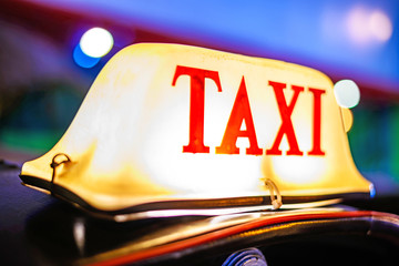 Thai Taxi (Tuk Tuk) sign with defocused lights blur , Chiang Mai