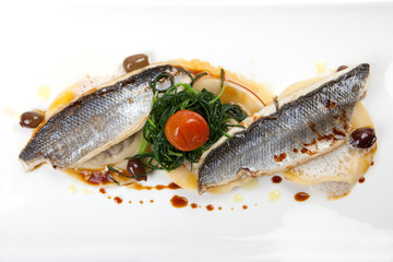 Filet von Wolfsbarsch mit Ravioli, Oliven, Spinat, Tomate