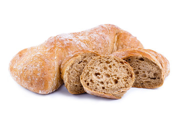 Tasty bread with slices on a white background.