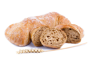 Tasty bread with slices on a white background.