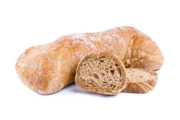 Tasty bread with slices on a white background.