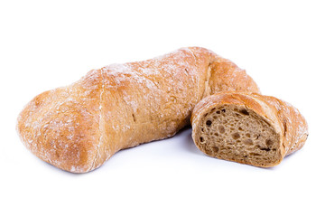 Tasty bread with slices on a white background.