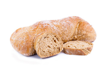 Tasty bread with slices on a white background.