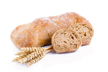 Tasty bread with wheat on a white background.