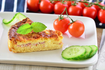Home made ham and cheese quiche with tomatoes and cucumber