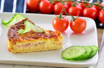 Home made ham and cheese quiche with tomatoes and cucumber
