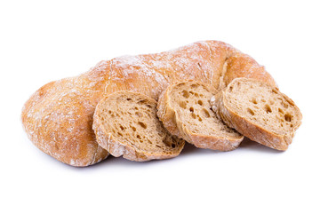 Tasty bread with slices on a white background.