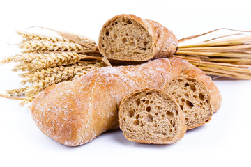 Tasty bread with wheat on a white background.