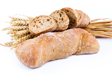 Tasty bread with wheat on a white background.