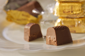Chocolate candy,cut in half, on the plate.