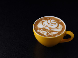 Cup of cappuccino on dark background. Latte art