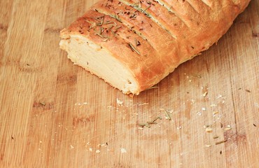 Loaf of white wheat homemade bread crumbs wooden background