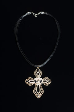 necklace with cross isolated on black background