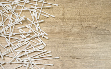 Q-tips on the wooden background
