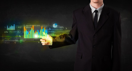 Young business person touching colorful charts and diagrams