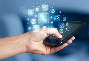 Hand holding smartphone with mobile app icons