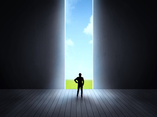 businessman walking to open gate