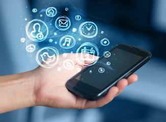 Hand holding smartphone with mobile app choices