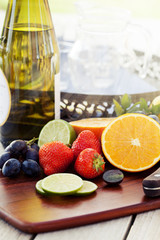 Variety of fruits and bottle of wine for preparing sangria