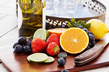 Variety of fruits and bottle of wine for preparing sangria