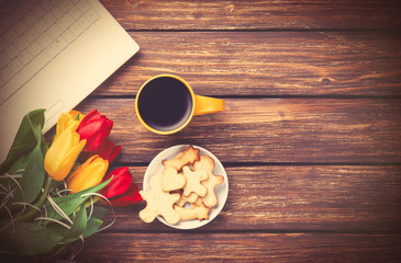 Cup of coffee and cookies with notebook
