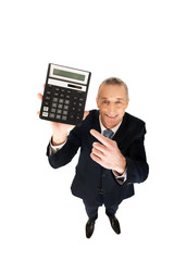 Happy businessman pointing on calculator