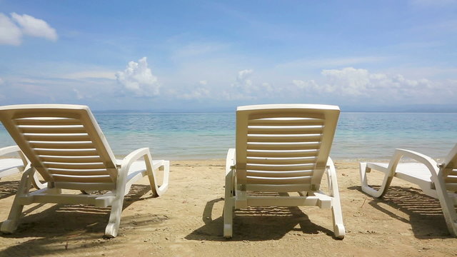 wo empty sunbeds on the Starfish beach, Panama