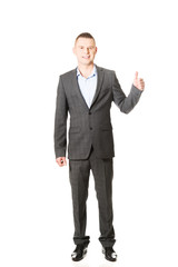 Young businessman gesturing ok sign