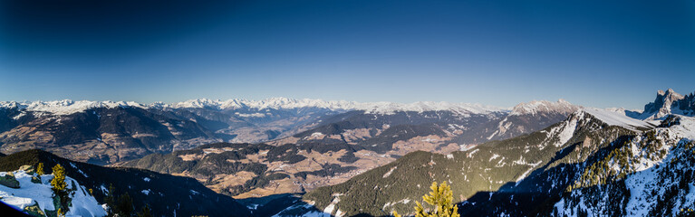 panorama of the Dolomites with snow-capped peaks and conifers