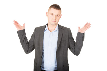 Businessman making undecided gesture
