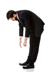 Young businessman bending down.