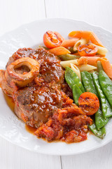 Ossobuco. Сross-cut veal shanks braised with vegetables.