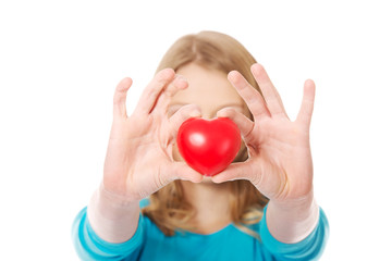 Young woman holding heart model