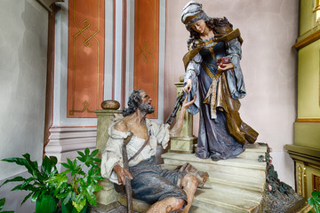 Saint Elizabeth with beggar in a charity gesture