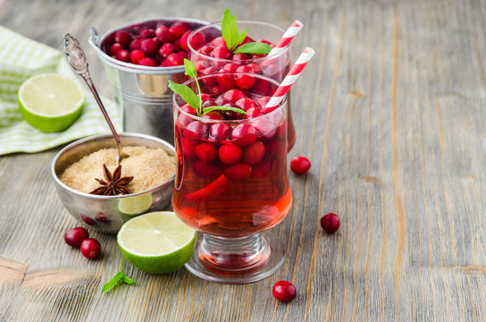Cranberry cocktail with berries and spices copy space background