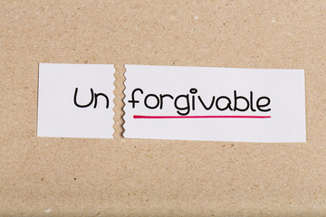 Sign with word unforgivable turned into forgivable