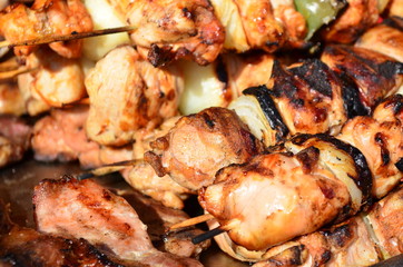 Grilled skewers of pork meat and vegetables