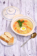 Chicken soup with egg and noodles submitted to a soup tureen