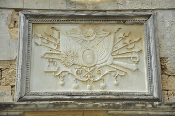 Fototapeta na wymiar Stove with emblem on Ottoman tower in city of Acre, Khan Al-Umda