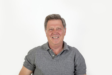 Obraz premium smiling mature man with grey polo shirt
