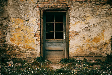 Fototapeta na wymiar Old door on abandoned building facade