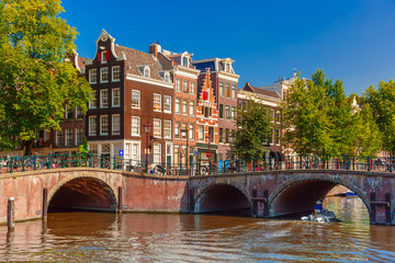 Naklejka premium City view of Amsterdam canal, bridge and typical houses, Holland
