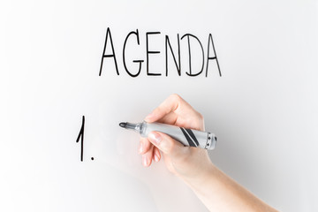 Agenda list written by hand on a white board.